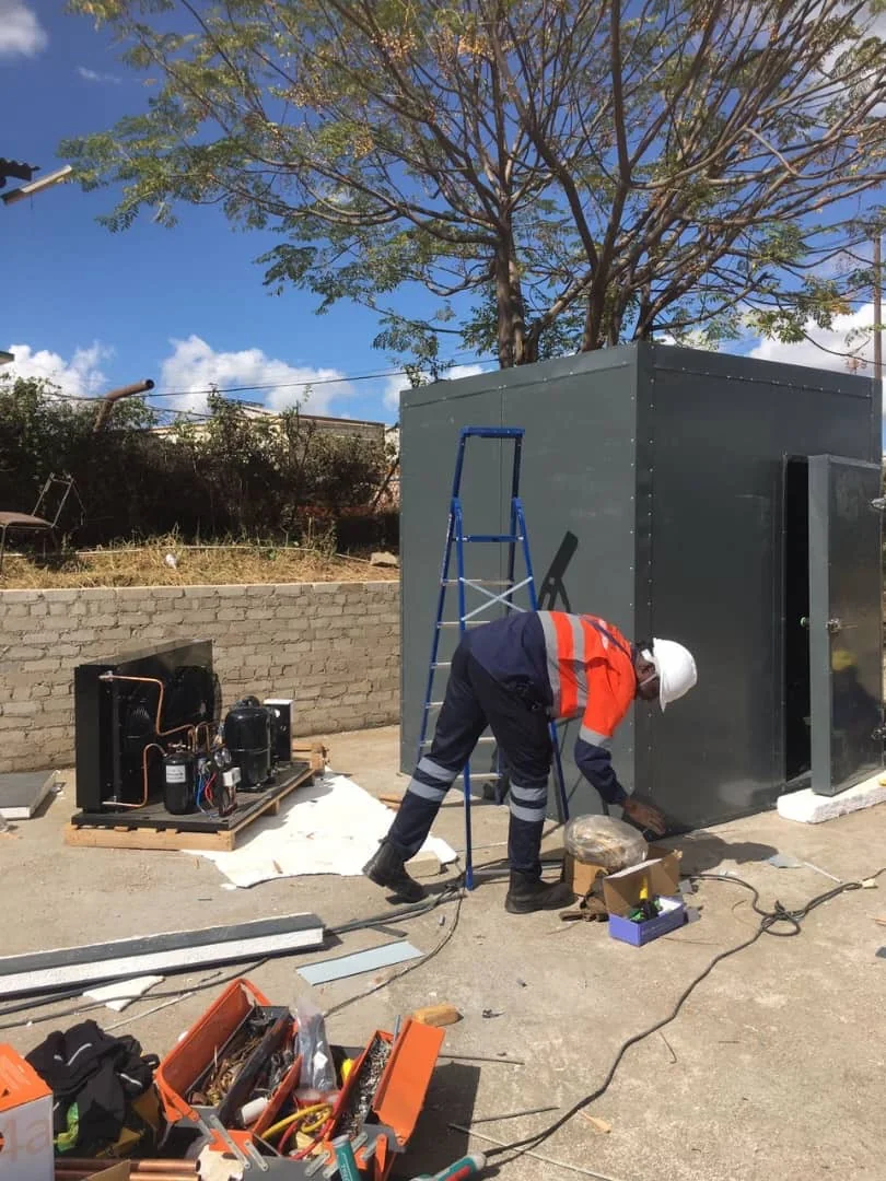 Global Climate & Power Engineering technician working on a refrigeration project