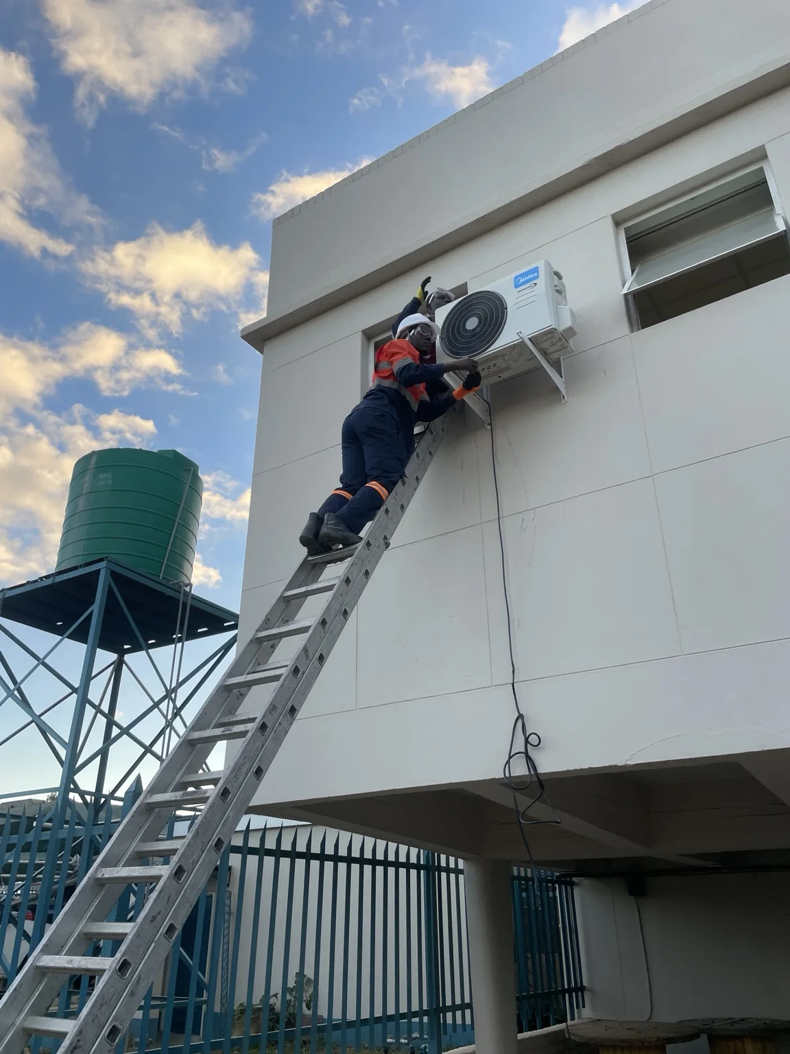 Technician working on air-conditioning equipment