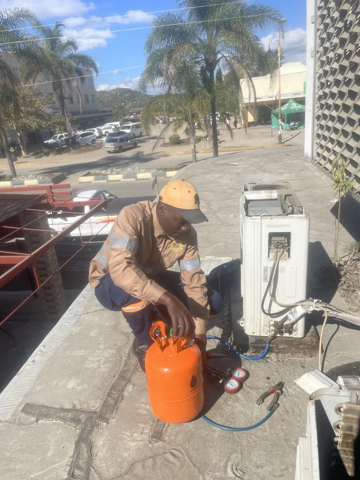 Technician servicing air conditioning equipment at Empower Bank Mutare