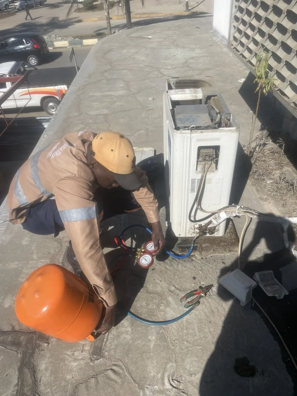 Technician servicing Empower Bank air conditioner