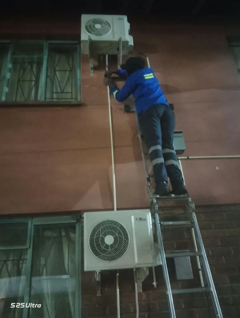 Technician servicing air-conditioning equipment at ZIMRA Forbes Border Post
